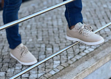 Charger l&#39;image dans la galerie, A man in blue jeans poses on a metal rail-guard with his beige hemp shoes.